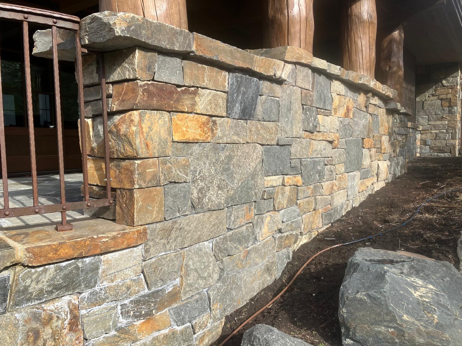 Exterior retaining wall with dimensional stone columns